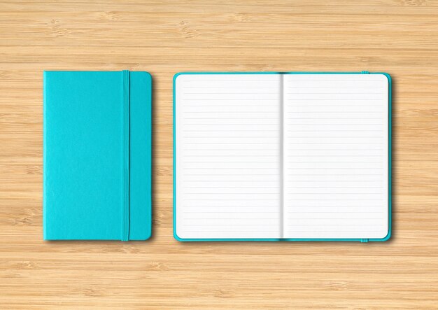 Aqua blue closed and open lined notebooks