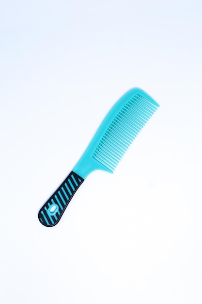 An Aqua Blue Comb in The Minimalist White Background with Flat Lay Shot, Portrait Mode