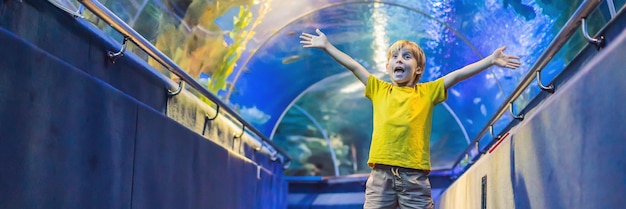 Aquarium and boy visit in oceanarium underwater tunnel and kid wildlife underwater indoor nature