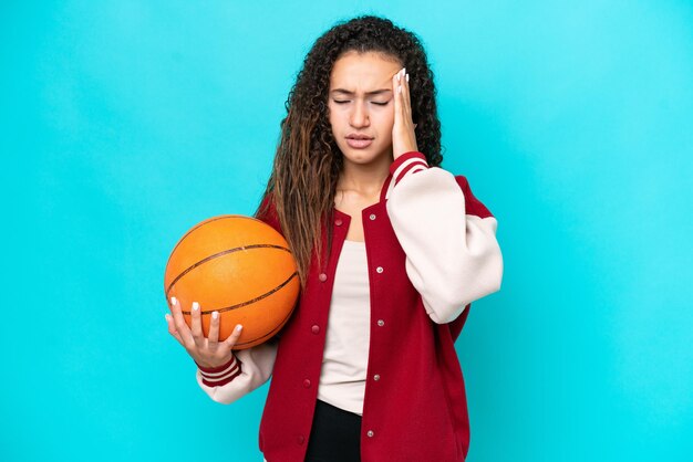 Arab basketball player woman isolated on blue background with headache