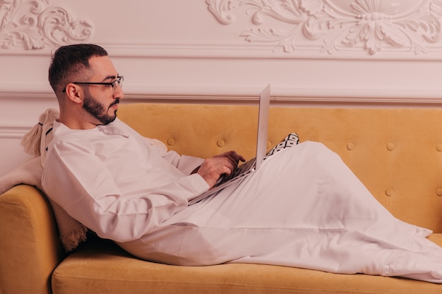 Arab businessman working on laptop computer at home. High quality photo