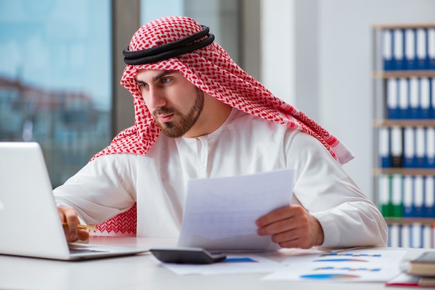 Arab businessman working on laptop computer