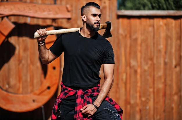 Arab hipster beard man lumberjack hold axe