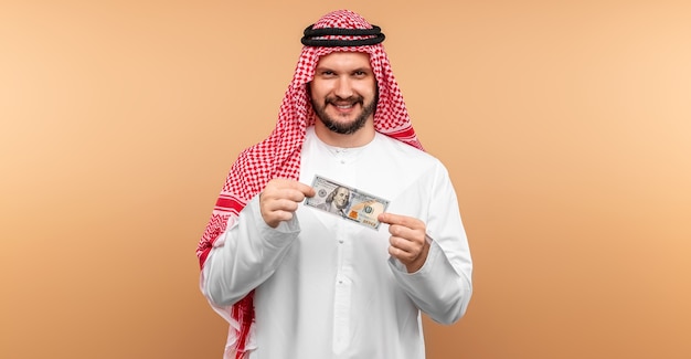 Arab man businessman in national clothes rejoices in dollars in his hands, great profit.