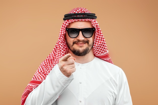 An Arab man, a businessman in a national suit with black glasses.