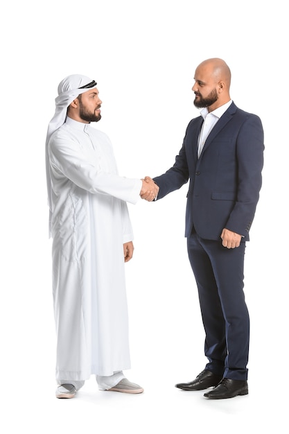 Arab man and his business partner shaking hands on white surface