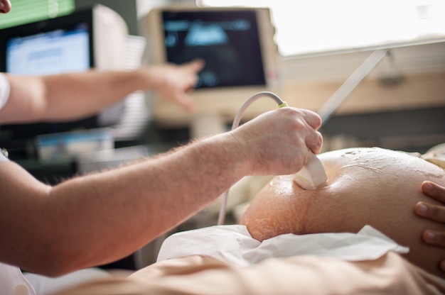 Arab Muslim woman checking her baby health with sonar