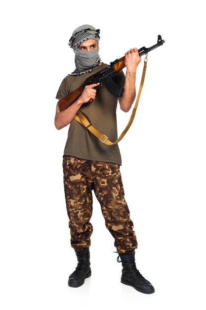 Arab nationality in camouflage suit and keffiyeh with automatic gun on white background with reflection