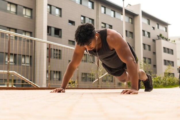 Arab strong young man doing sports in the city doing some pushups