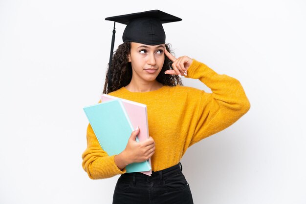 Arab university graduate woman holding books isolated on white background having doubts and thinking