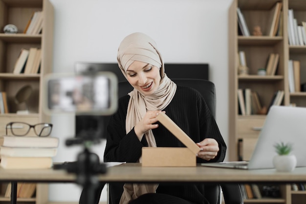 Arab woman using smart phone camera for creating content