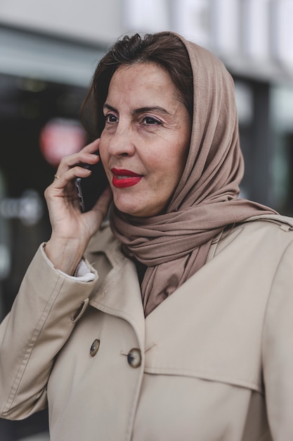 Arab woman with hijab talking on the phone