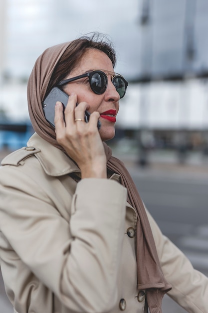 Arab woman with hijab talking on the phone