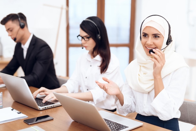 An Arab woman works in a call center.