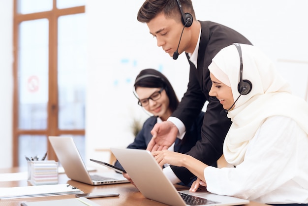 An Arab woman works in a call center.