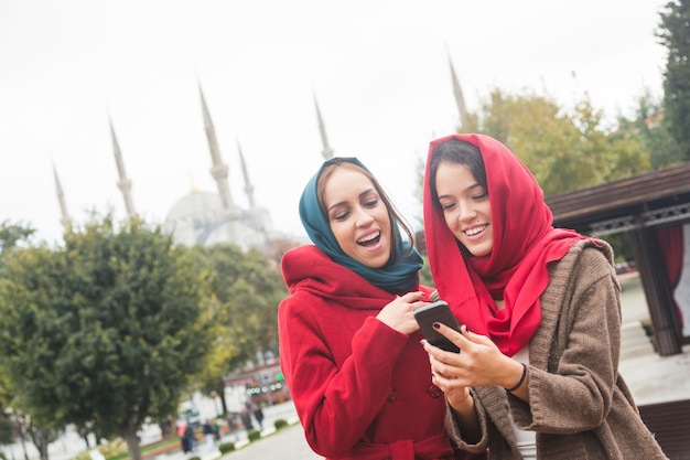 Arab Women Wearing Veil Using a Smart Phone in Istanbul