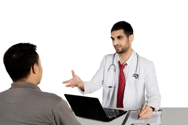 Arabian doctor talking with his patient on studio