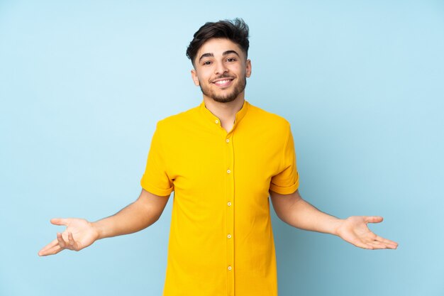 Arabian handsome man over isolated wall happy and smiling