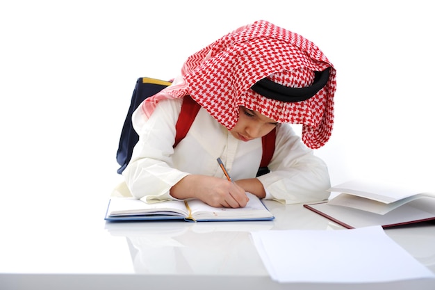 Arabian kid writing on the table