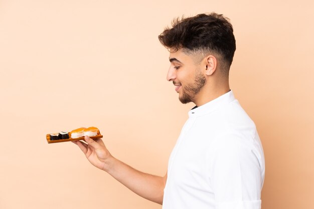 Arabian man eating sushi