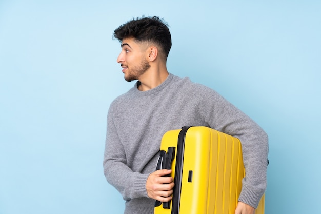 Arabian man isolated in vacation with travel suitcase