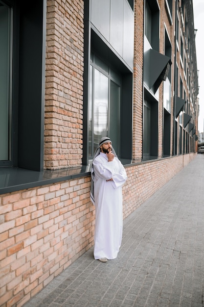 Arabian man. Man in traditional orient clothing in the city street