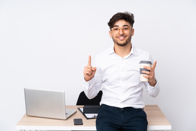 Arabian man in a office on white wall pointing up a great idea