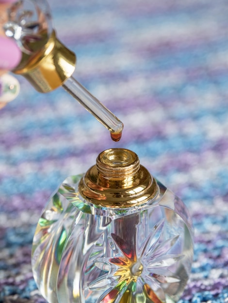 Arabian oud attar perfume or agarwood oil fragrances in crystal bottle.