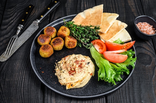 Arabic cuisine Hummus chickpea, falafel, pita bread and fresh vegetables.