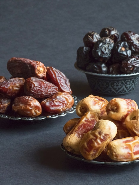 Arabic dates fruits are laid out on a dark table