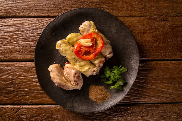 Arabic food. Appetizing cabbage rolls on wood background