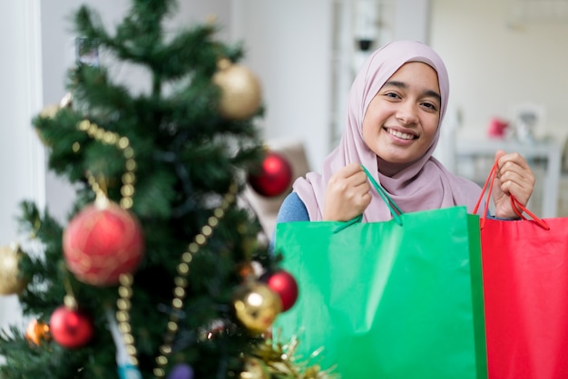 Arabic girl with New year holidays tree