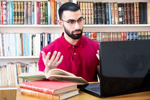 Arabic man using a laptop during or meetings for studying and teaching through online channels