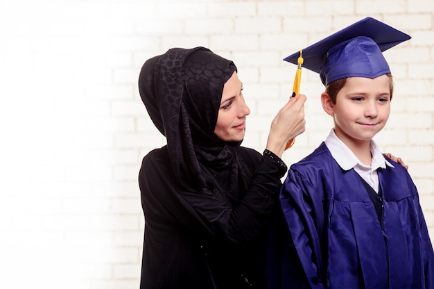 Arabic mother posing with graduated son