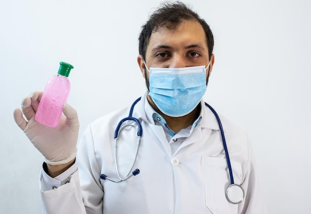 Arabic muslim doctor wearing mask and presenting hygiene and protection products