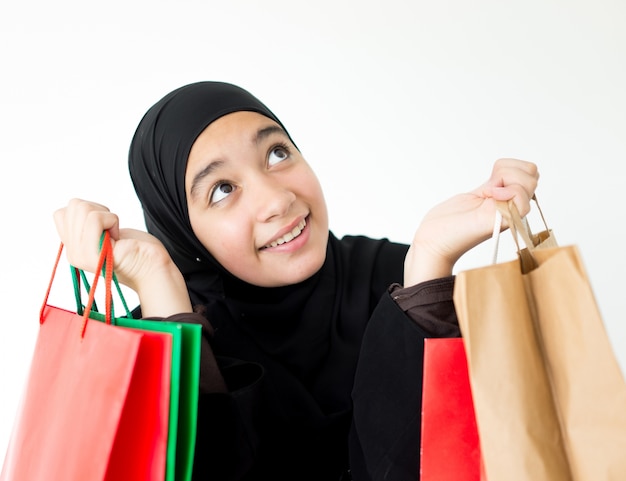 Arabic Muslim girl with shopping bags