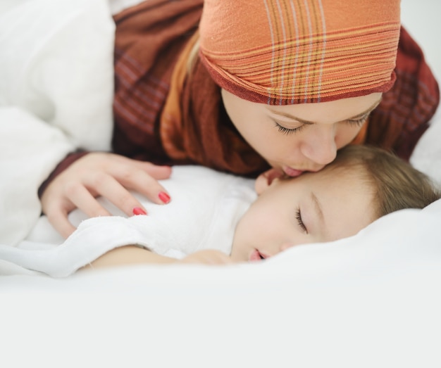 Arabic Muslim mother playing and taking care of her baby