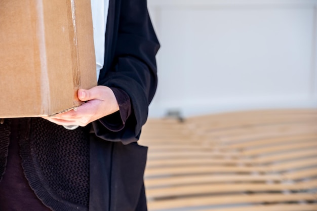 Arabic muslim woman holding carton boxes in her hand