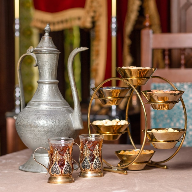 Arabic teapot glass and nuts pot close up