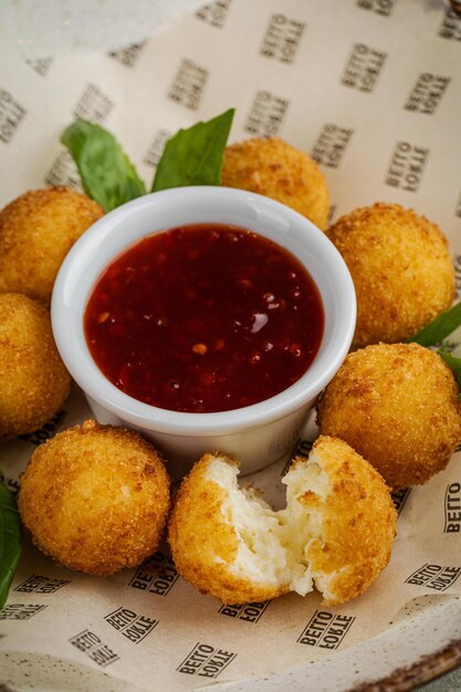 Arancini food and tomato sauce fried rice balls with sweet hot\
sauce sicilian cuisine