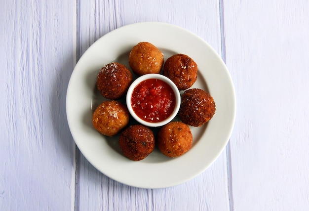 Arancini with mushrooms and cheese - traditional sicilian hot appetizer