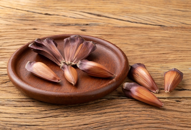 Araucaria pine tree seeds over wooden plate