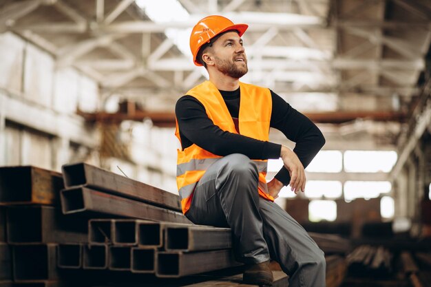 Arbeider bij de staalfabriek die het materiaal controleert