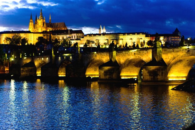 Arch bridge over river against buildings in city