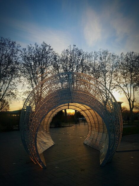 Arch bridge over river against sky during sunset