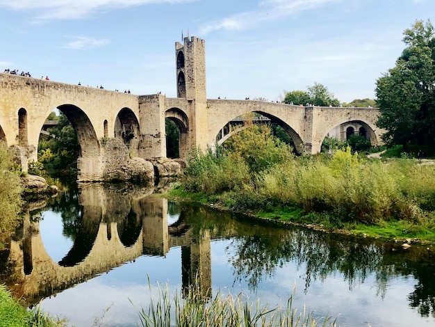 arch bridge over river against sky