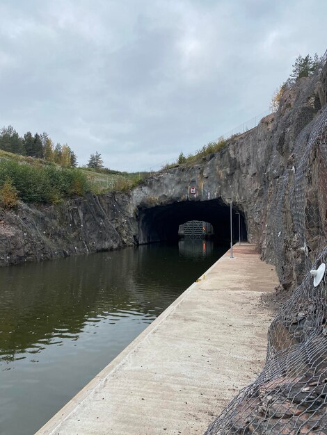 Arch bridge over river against sky