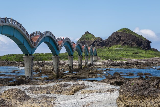 Foto ponte ad arco sulle rocce contro il cielo