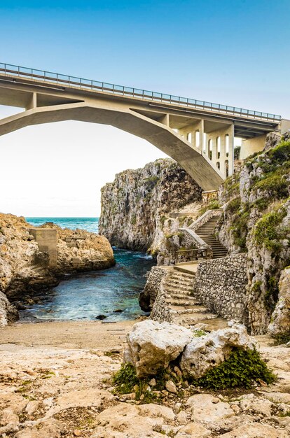 Foto ponte ad arco sul mare contro un cielo limpido