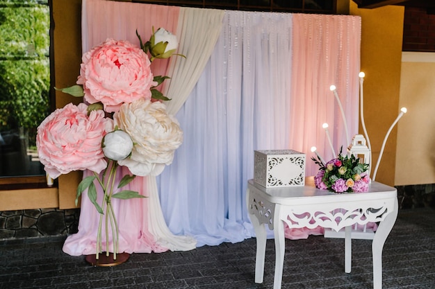 Arch and wall decorated with flowers Vintage wedding gift box for money and greeting cards on the table